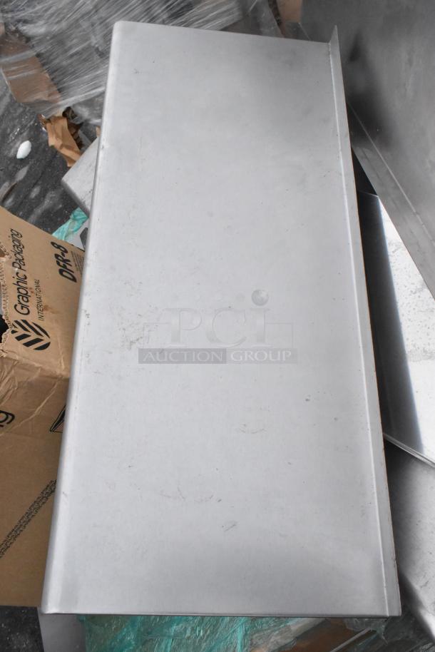 Pallet lot with metal shelves, poly bins, bowls, and table base posts. Mixed condition items on cardboard packaging.