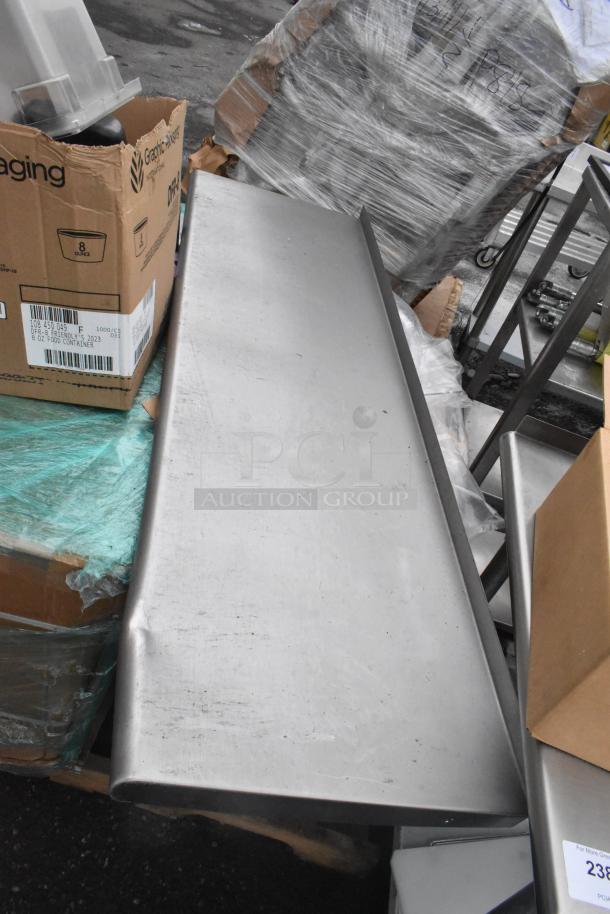 Pallet with various items including shelves, plastic bins, metal table base, and boxes. Items have signs of wear.