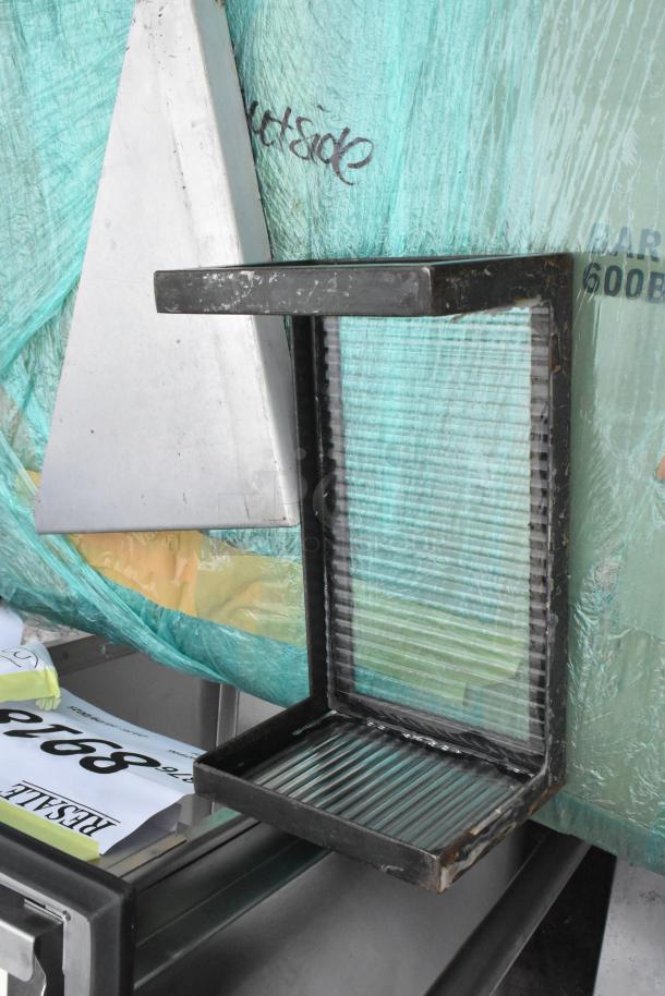 Pallet lot with metal shelf, poly drop-in bin, and metal triangle piece; auction tag visible.