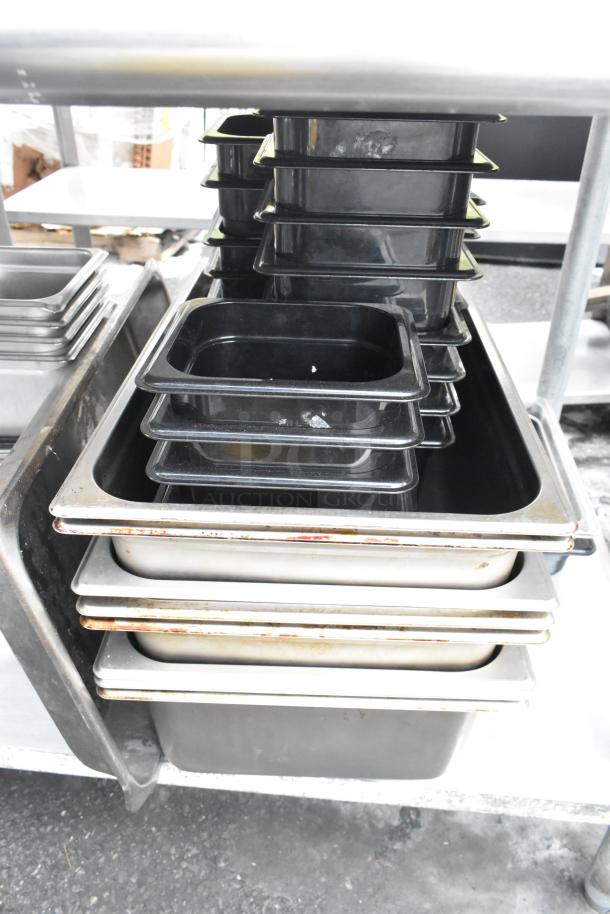 Commercial table with under shelf, featuring stacked black and silver pans. Used condition, ideal for kitchen storage.
