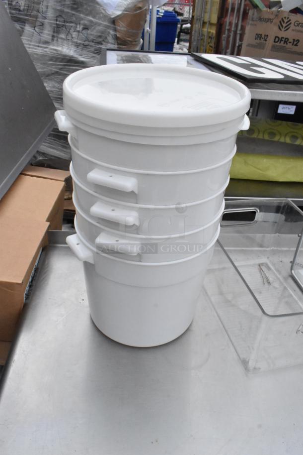 Commercial table with under shelf, topped with stacked white storage tubs and various containers. Good condition.