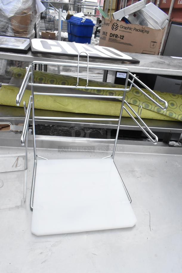 Stainless steel commercial table with undershelf, includes various kitchen items. Visible labeling and packaging materials on table.