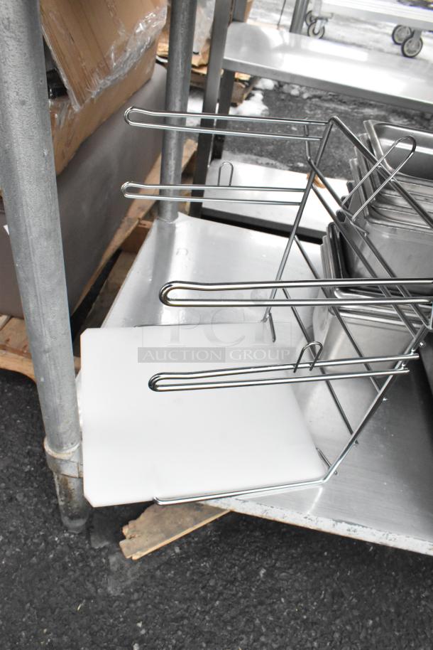 Commercial table with under shelf, includes metal storage rack and contents. Sturdy metal construction, good condition.