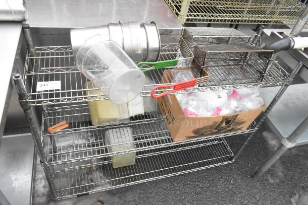 Chrome finish 3-tier wire shelving unit with fry baskets, cylindrical bins, and a box of contents. Buyer must dismantle.