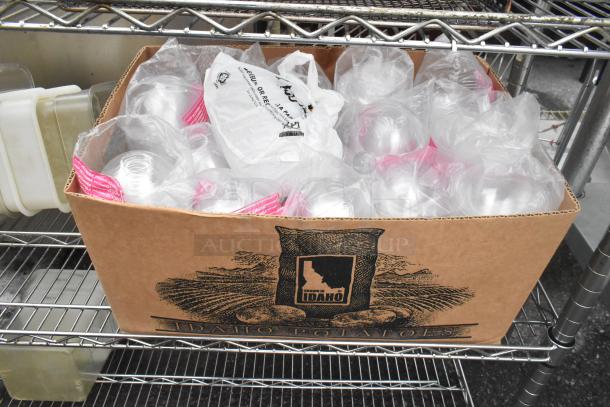 Chrome finish 3-tier wire shelving unit with fry baskets, cylindrical bins, and full cardboard box. Buyer must dismantle.