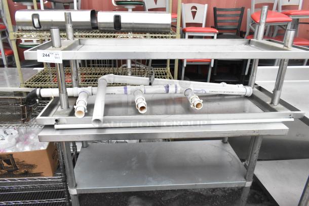 Stainless steel tables with undershelf, featuring plumbing fixtures. Good condition, lot number 244.
