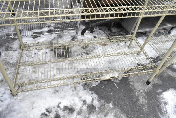 Tan finish 3-tier wire shelving unit, showing signs of wear. Buyer must dismantle for shipping. Consider freight charges.