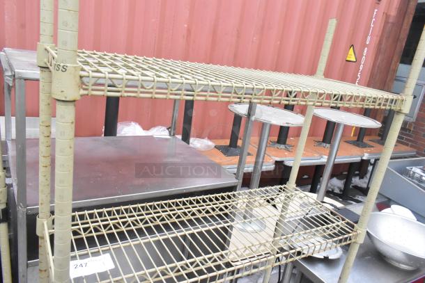 Tan finish 4-tier wire shelving unit. Visible wear; buyer must dismantle. Consider freight charges for shipping.