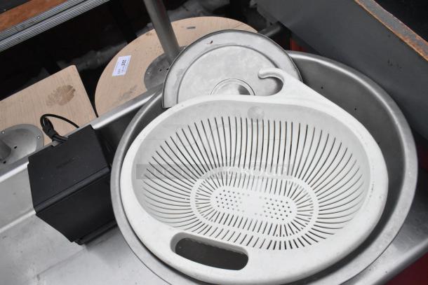 Commercial table with backsplash and two under shelves, stainless steel, used condition, includes Epson device and strainer.