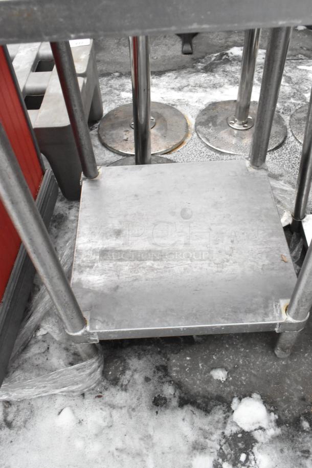 Stainless steel commercial table with under shelf, used condition, sturdy design, ideal for restaurant kitchens.