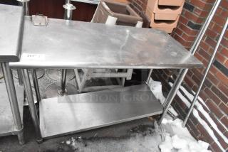 Commercial table with under shelf, sturdy metal construction, can opener mount, signs of wear, 25" wide, ideal for kitchens.