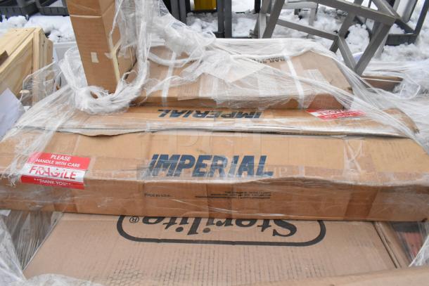 Auction lot with 8 new items, including Imperial-labeled boxes and fragile tags. Scratch and dent condition.