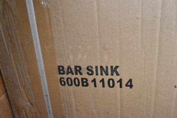Cardboard box labeled "BAR SINK 600B11014," part of a lot including new scratch and dent items like an anti-fatigue floor mat.