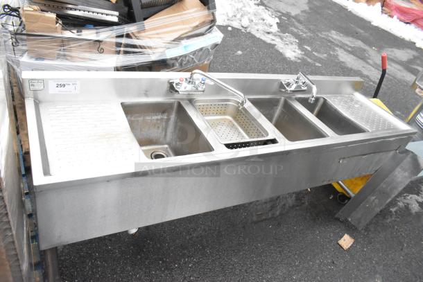 Commercial 4 bay back bar sink with dual drain boards, faucets, and handles. Stainless steel, includes perforated strainer.