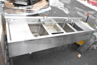 Commercial 4 bay back bar sink with dual drain boards, faucets, and handles. Stainless steel, includes perforated strainer.