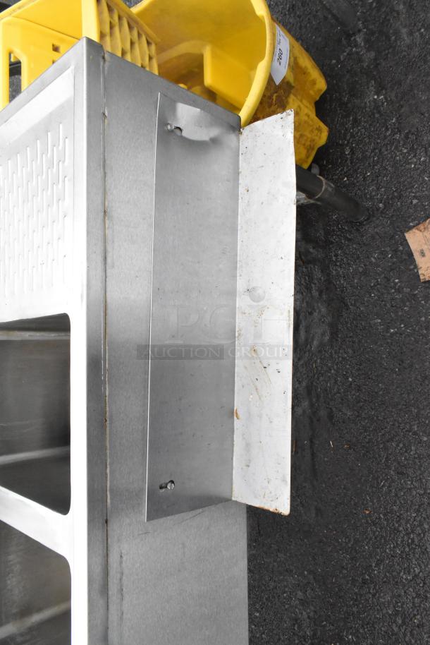 Commercial 4-bay back bar sink with dual drain boards, stainless steel, includes faucets and handles, in good condition.