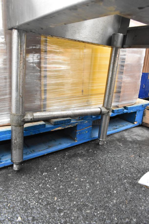 Commercial 4 bay back bar sink with dual drain boards, visible sturdy stainless steel legs, faucets, and handles.