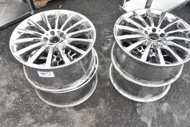 4 AMG chrome finish rims, used condition, visible scuffs. Auction label "262", 4 rims included in bid.