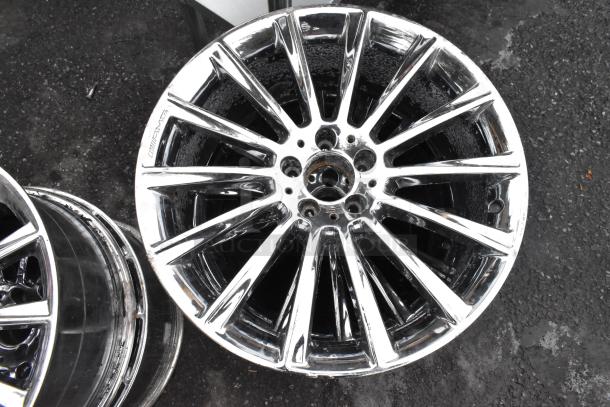 4 AMG chrome finish rims with multi-spoke design, excellent condition, visible AMG branding on spokes.