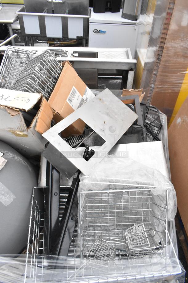 Pallet lot with metal baskets, light fixture, hose, and boxes. Varied items in used condition, ideal for bulk buyers.