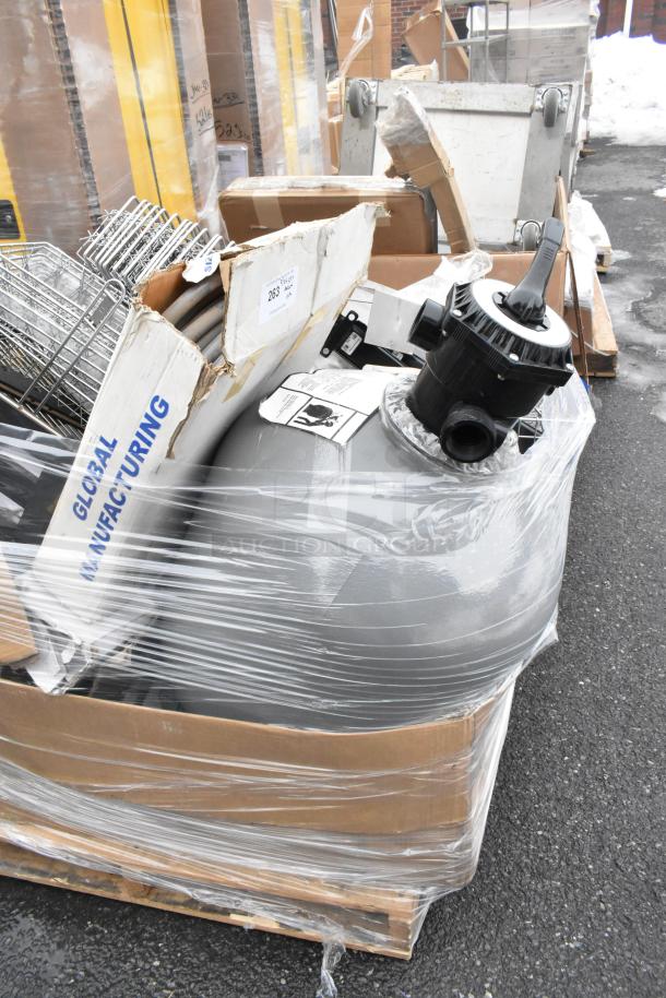 Pallet lot with metal baskets, a light fixture, and a hose, wrapped and labeled from Global Manufacturing.
