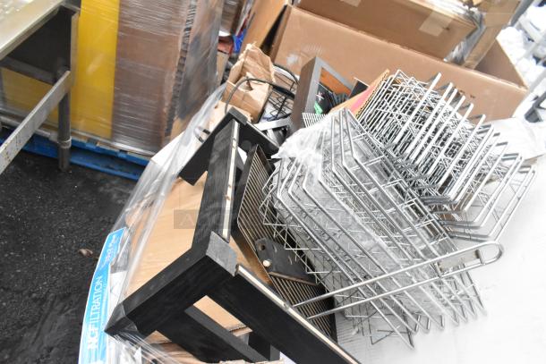 Pallet lot with metal baskets, light fixture, and hose. Includes various items in used condition, ideal for resale.