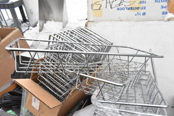 Pallet of metal baskets, cardboards, and other items, partially visible hose and light fixture in the background.