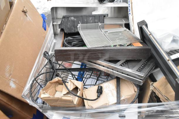 Pallet lot with metal baskets, light fixture, hose, and various items. Mixed condition, visible cables and packaging.