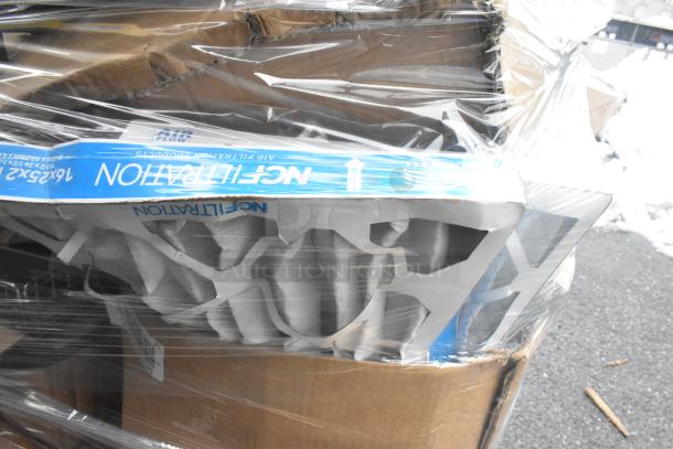 Pallet containing assorted items including metal baskets, light fixture, hose, and a box of air filtration products. Items are wrapped in plastic, condition appears varied.