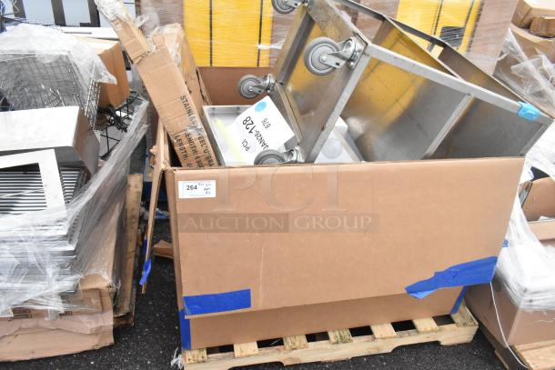 New scratch and dent items including Koala Kare Infant Seat Kradles, utility sink, and ice bin on pallet with packaging.