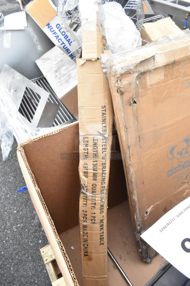 Cardboard boxes labeled with "Stainless Steel U Bracing," containing new Koala Kare items, utility sink, and ice bin, in scratch and dent condition.