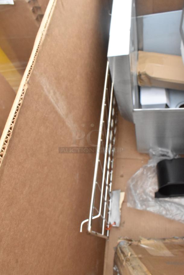 Box with scratch and dent items including Koala Kare infant seat kradles, utility sink, and ice bin. Appears unused.