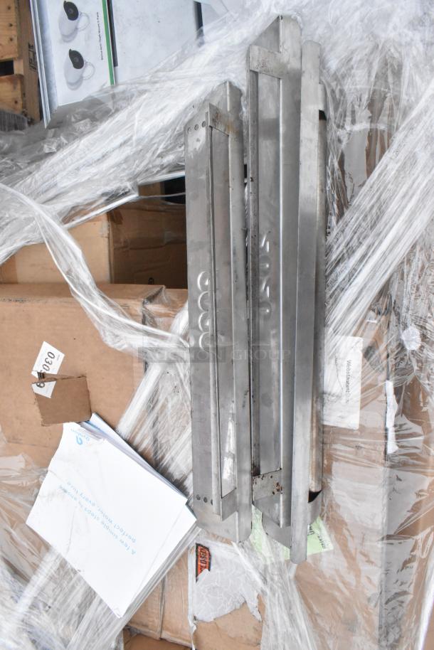 Seven brand new scratch and dent items, including Avantco over shelf and Watts grease trap, wrapped in plastic.