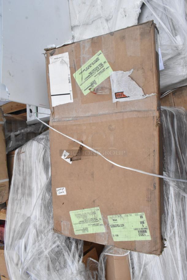 Cardboard box with visible shipping labels and packaging tape. Contains scratch and dent items including Avantco Over Shelf and Watts Grease Trap.