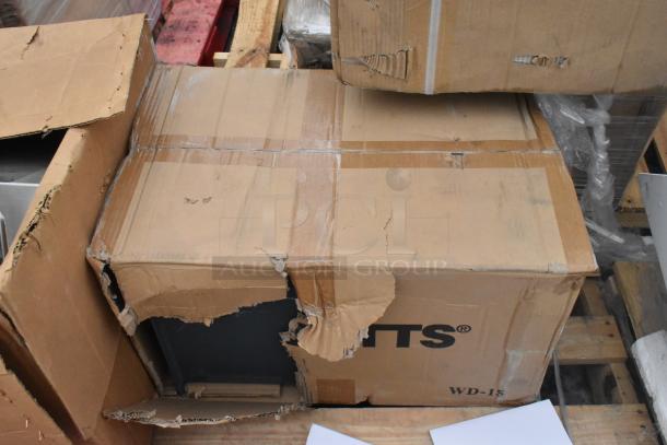 Cardboard box labeled "WD-15" with visible dents and tears, containing new items like an Avantco over shelf and Watts grease trap.