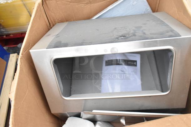 Cardboard box with stainless steel item, possibly Avantco over shelf, showing minor dents. Includes product label and documentation.