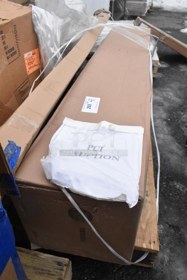 Cardboard boxes containing scratch and dent items, including Avantco over shelf, Watts grease trap, labeled for auction.
