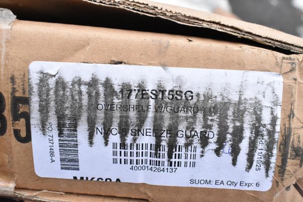 Cardboard box with a label showing "177EST5SG Overshelf w/Guard 71''" and partially obscured barcodes. Box appears intact.