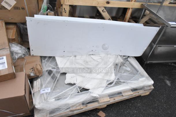 Lot of new scratch and dent items, including WEBATL184874 unit, on a pallet with visible packaging and labels.