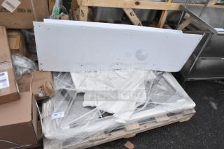 Lot of new scratch and dent items, including WEBATL184874 unit, on a pallet with visible packaging and labels.