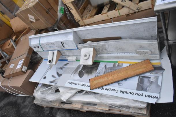 Lot of brand new scratch and dent items including WEBATL184874 unit. Mixed condition, some in packaging, various materials.