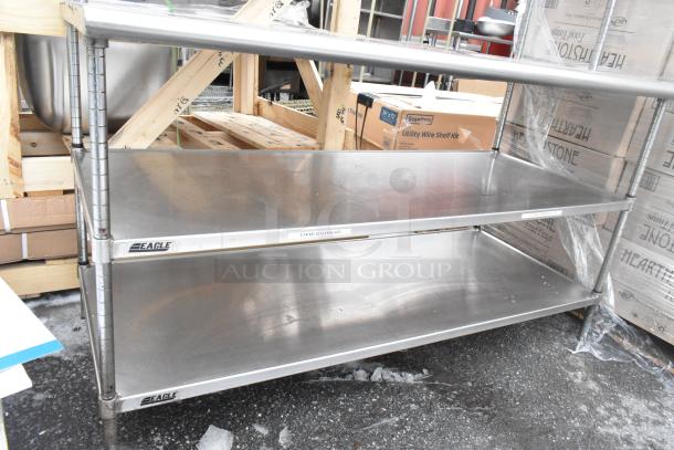 Commercial stainless steel table with two-tier over shelf and two under shelves, Eagle brand, clean condition, sturdy construction.