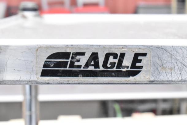 Eagle commercial table with 2-tier over shelf and 2 under shelves, steel construction, used condition. Eagle logo visible.