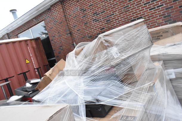 Alt text: 36 new scratch and dent items, including a butane range and kitchen supplies, in a wrapped pallet outdoors.