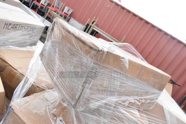 36 brand new, scratch-and-dent items including butane range, casters, plates, and trays, wrapped in plastic for auction.