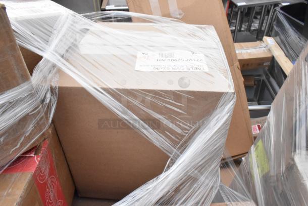 Boxes wrapped in plastic, containing brand new scratch and dent items like a butane range, casters, plates, and trays.