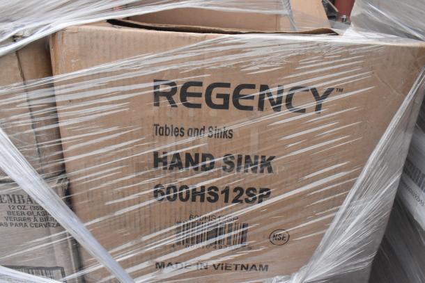 Box of Regency hand sinks, model 600HS12SP, wrapped in plastic. Label indicates Made in Vietnam, NSF certified.