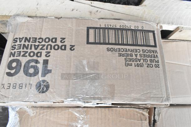 Cardboard box labeled "Libbey" with "2 Dozen Glasses," showing signs of wear. Part of 36 new scratch and dent items auction.