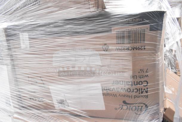 Plastic-wrapped pallet of boxed items, including Arcoroc Rocks glasses, soup carrier, and dessert cups. Barcodes visible.