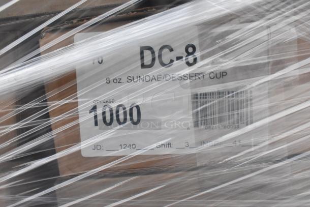 Box labeled "DC-8 8 oz. Sundae/Dessert Cup," wrapped in plastic, indicating new items with minor imperfections.